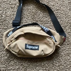 Supreme bag has a tan look with black and white